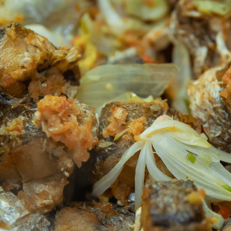 Fried Fish garnished with onions and peppers from Sam's Recipe Book