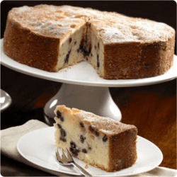 Blueberry and Lemon Polenta Cake On a cake platter with a slice cut out and served on a side dish with dessert fork