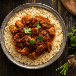 Chicken Vindaloo Sauce sprinkled with coriander and served on rice