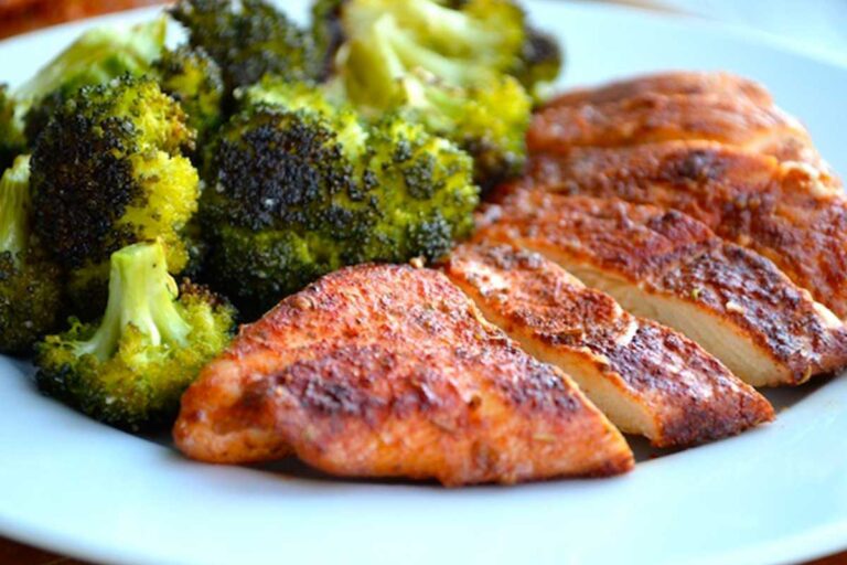 Grilled chicken served with broccoli on a white dish from Sam's Recipe Book for chicken recipes