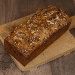 Banana cake fresh from the oven placed on a square wooden pizza board