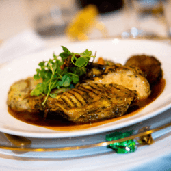 Basil Chicken (Three Cup Chicken) served on a white dish and garnished with basil