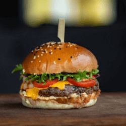 A quick dinner idea - beef burger with lettuce, tomatoes, cheese, and beef patties held down with a skewer