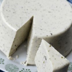 A block of cashew cheese with a slice cut out