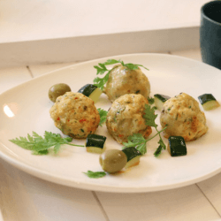 Air fryer chicken meatball garnished and served on a white dish