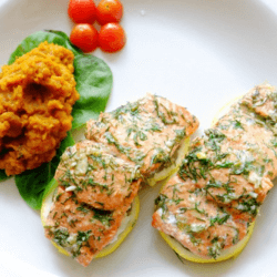 Baked Salmon on lemon and garnished with green onions and some tomatoes on the side