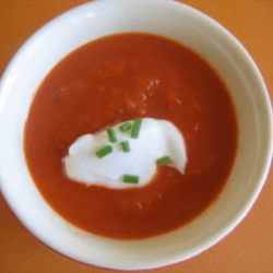 Red Pepper Soup served in a white bowl and garnished