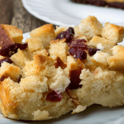 Cranberry bread pudding served on a white plate